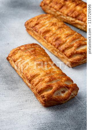Golden Puff pastry stuffed with sausage and cheese 113726996