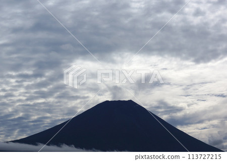 Mount Fuji silhouette under cloudy sky 113727215