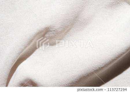 A soft, pure white fabric background with a delicate grid pattern. The texture A soft, pure white fabric background with a delicate grid pattern. The texture 113727294