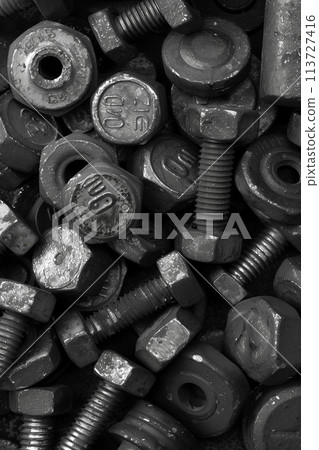 Assorted new galvanized bolts and nuts for abstract industrial pattern Assorted new galvanized bolts and nuts for abstract industrial pattern 113727416
