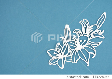 Carve of white paper flower and leaves with copy space on a blue background. 113728046