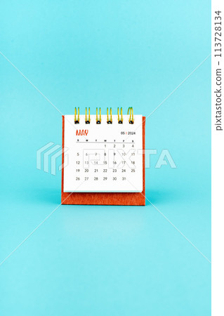 May 2024 white desk calendar on blue background. May 2024 white desk calendar on blue background. 113728134