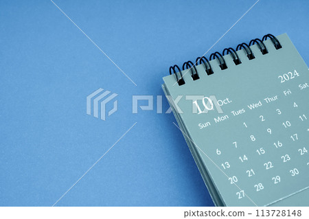 October 2024 desk calendar on blue color background. C 113728148