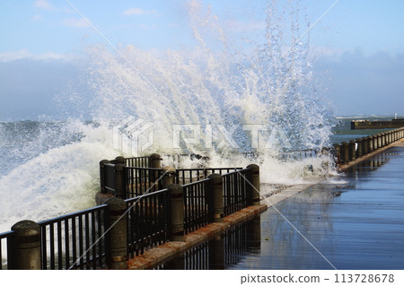 Waves beyond breakwater 113728678
