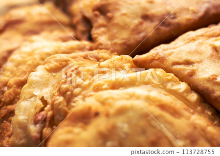 Close up of fried food with pieces missing, tempting dish 113728755