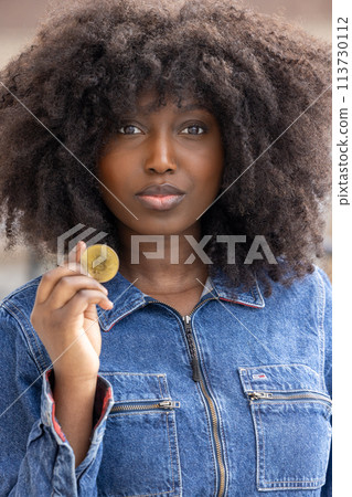 Curious Woman Holding Bitcoin in Denim Outfit Curious Woman Holding Bitcoin in Denim Outfit 113730112