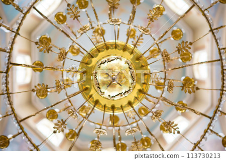 ceiling in the church with the illuminator. church lamp look from below ceiling in the church with the illuminator. church lamp look from below 113730213