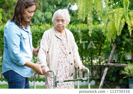 Caregiver help Asian elderly woman disability patient sitting on wheelchair in park, medical concept. 113730338