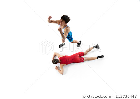 Top view. Two male wrestling athletes in blue and red uniform, showing victory and defeat isolated on white background 113730448