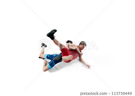 Young men, athletes compete fiercely in wrestling match, displaying determination and skills isolated on white background 113730449