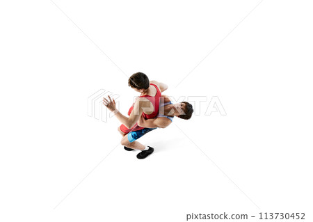 Top view. Wrestlers in action, two male athletes wrestling, training isolated on white background 113730452