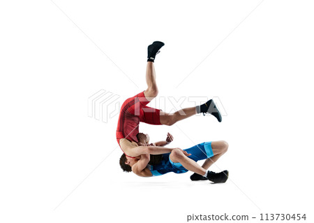 Young men, athletes engaged in challenging wrestling match, demonstrating resilience and skills isolated on white background 113730454