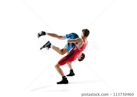 Young men, wrestlers showing athleticism and determination as they grapple isolated on white background 113730460