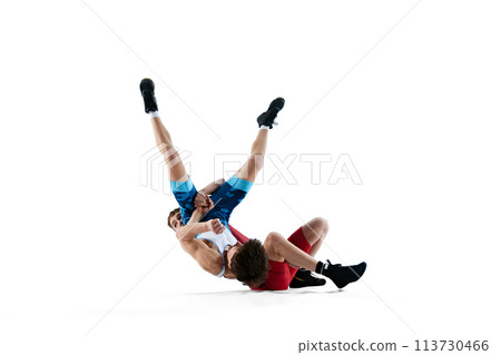 Two male wrestlers engage in battle, showing strength and skills during competition isolated on white background 113730466
