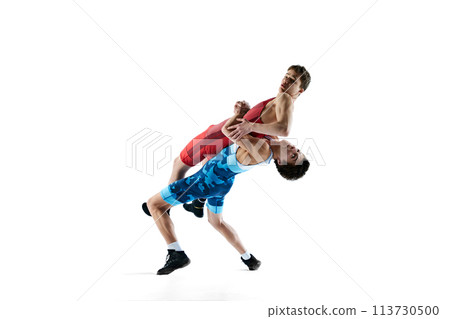 Male wrestlers, athletes wrestling in dynamic and intense match, showing athleticism and determination isolated on white background 113730500