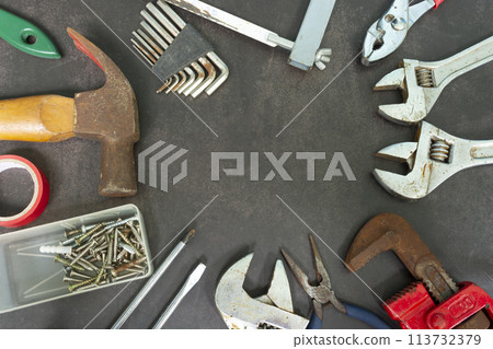 Old tools on concrete floor. Renovation, maintenance and repairing concept. Old tools on concrete floor. Renovation, maintenance and repairing concept. 113732379