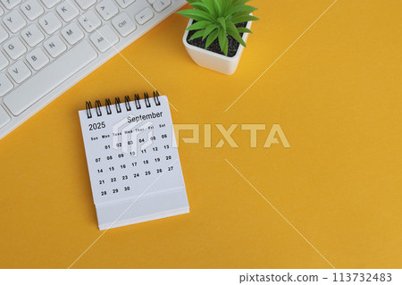 September 2025 desk calendar on yellow background. Directly above. Flat lay. September 2025 desk calendar on yellow background. Directly above. Flat lay. 113732483