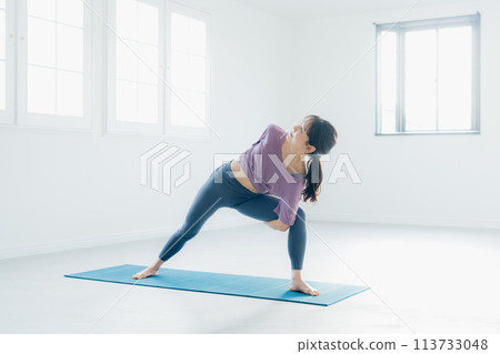 Woman practicing yoga in a yoga studio 113733048