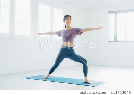 Woman practicing yoga in a yoga studio 113733049