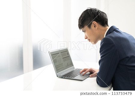 A male businessman having trouble creating documents on a laptop 113733479