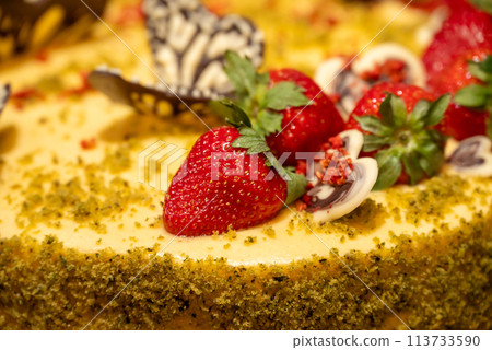 a close up of a cake with strawberries on top 113733590