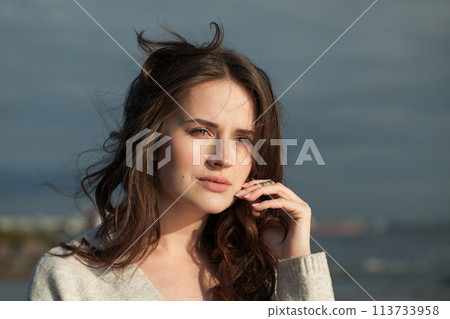Smiling brunette woman with fresh skin, natural make-up and healthy wavy brown hair Smiling brunette woman with fresh skin, natural make-up and healthy wavy brown hair 113733958