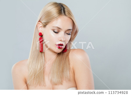 Attractive blonde woman with fashion jewelry eraring, blond hairstyle, clean fresh skin  113734928