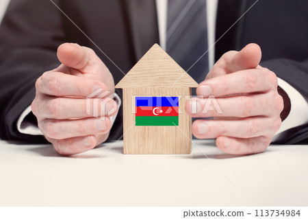 Businessman hand holding wooden Home model with Azerbaidjani flag. insurance and property concepts Businessman hand holding wooden Home model with Azerbaidjani flag. insurance and property concepts 113734984