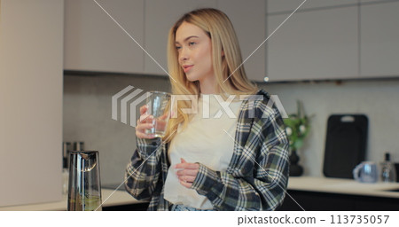 Attractive girl drinking water on domestic kitchen. Health and diet concept. Attractive girl drinking water on domestic kitchen. Health and diet concept. 113735057