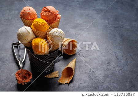Assorted ice cream flavours in delightful waffle cones 113736087