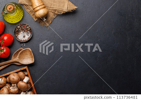Spices, olive oil, and utensils on cooking table 113736481