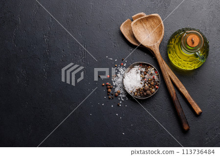 Spices, olive oil, and utensils on cooking table Spices, olive oil, and utensils on cooking table 113736484