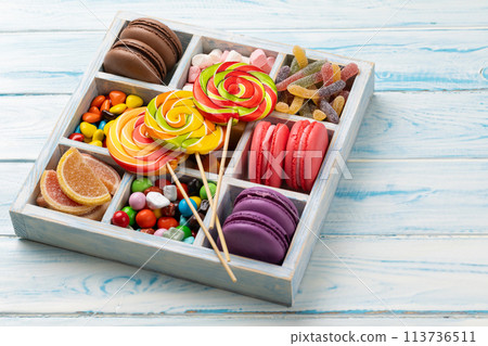 Various colorful candies, lollipops, and macaroons 113736511