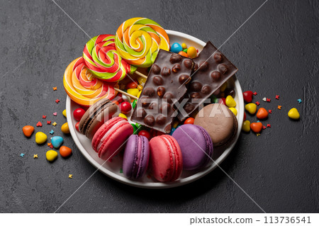 Various colorful candies, lollipops, and macaroons Various colorful candies, lollipops, and macaroons 113736541