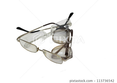 Three different glasses lie on top of each other isolated on white background Three different glasses lie on top of each other isolated on white background 113736542