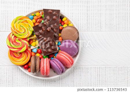 Various colorful candies, lollipops, and macaroons Various colorful candies, lollipops, and macaroons 113736543