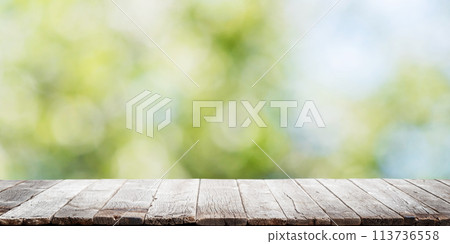 Empty wooden table over bokeh natural background 113736558