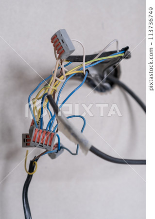 Apartment renovation. Electrical wiring. Wires sticking out of the wall. 113736749