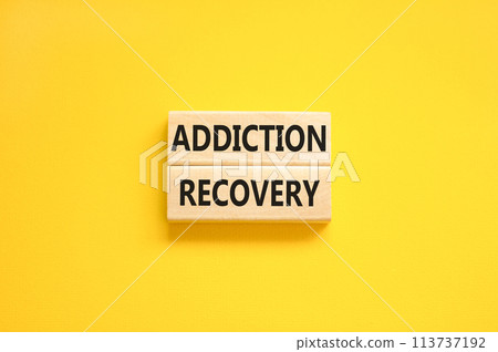 Addiction recovery symbol. Concept words Addiction recovery on beautiful wooden blocks. Beautiful yellow table yellow background. Psychology addiction recovery concept. Copy space. Addiction recovery symbol. Concept words Addiction recovery on beautiful wooden blocks. Beautiful yellow table yellow background. Psychology addiction recovery concept. Copy space. 113737192