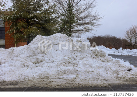 During winter, parking lots near apartment buildings are covered with snow 113737426