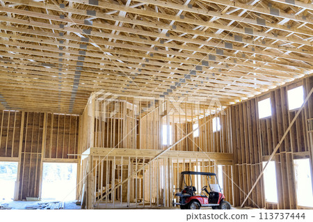 Beams at wooden trusses framework construction on a new house under construction Beams at wooden trusses framework construction on a new house under construction 113737444