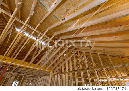Construction of a new home is unfinished, including beams stick trusses, as well as roofing framing Construction of a new home is unfinished, including beams stick trusses, as well as roofing framing 113737474