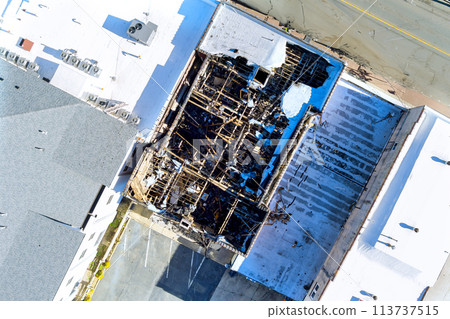After fire, a burned wooden house had its roof destroyed After fire, a burned wooden house had its roof destroyed 113737515