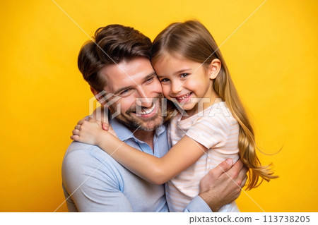 Loving dad, close-up with daughter, yellow backdrop, studio shot, playful interaction 113738205