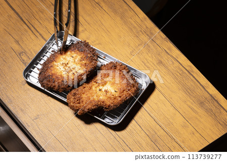 Deep frying tonkatsu in the home kitchen Deep frying tonkatsu in the home kitchen 113739277