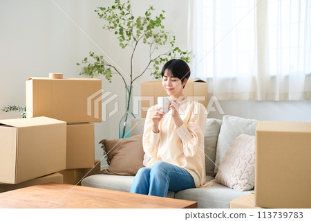 A woman surrounded by moving luggage 113739783