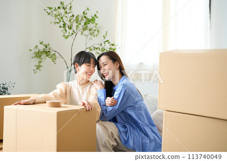 Same-sex couple moving into new home Same-sex couple moving into new home 113740049