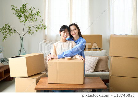Same-sex couple moving into new home 113740055