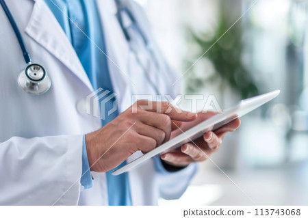 Healthcare professional using a tablet in a clinical setting 113743068