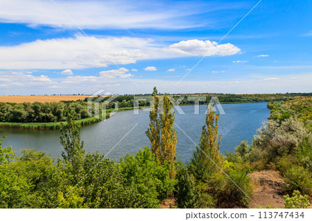 Summer landscape with beautiful river, green trees and blue sky Summer landscape with beautiful river, green trees and blue sky 113747434